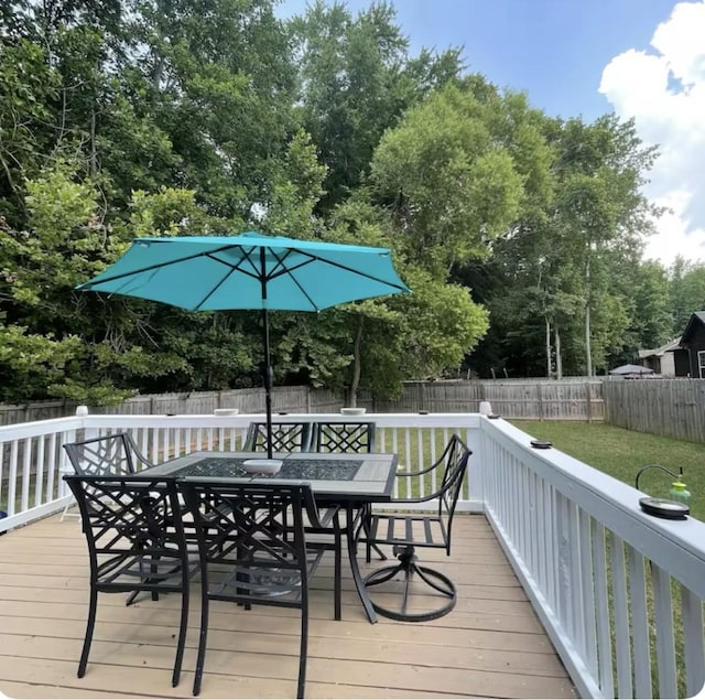 wooden terrace featuring a yard