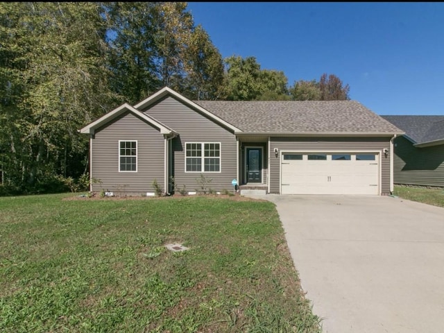 ranch-style house featuring a garage and a front yard