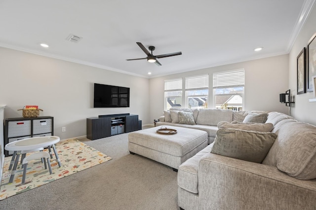 living room featuring ceiling fan, carpet, and crown molding