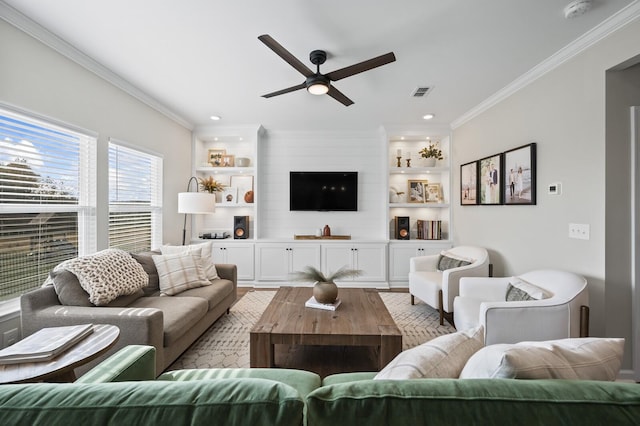 living room featuring ceiling fan, built in features, crown molding, and light wood-type flooring