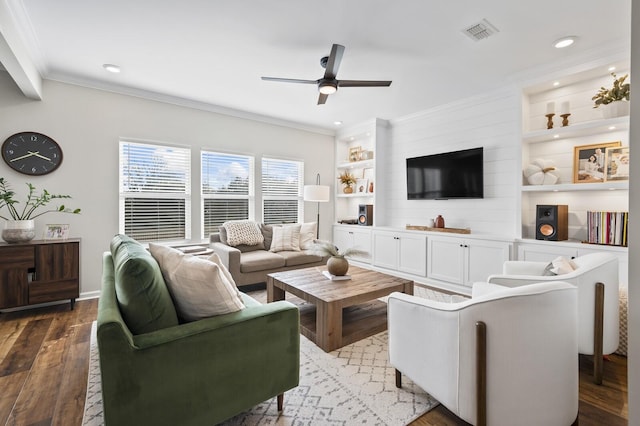 living room with ceiling fan, wood-type flooring, built in features, and crown molding