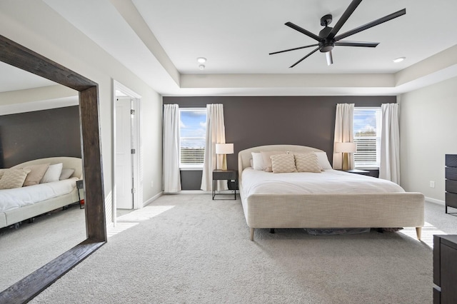 bedroom featuring ceiling fan, multiple windows, and carpet