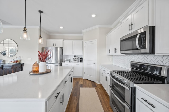 kitchen featuring white cabinets, a center island, stainless steel appliances, and tasteful backsplash