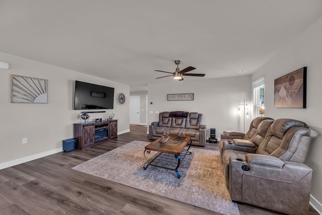 living room with ceiling fan and dark hardwood / wood-style floors