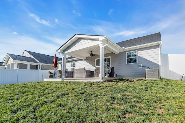 back of house featuring ceiling fan, a lawn, and a patio area