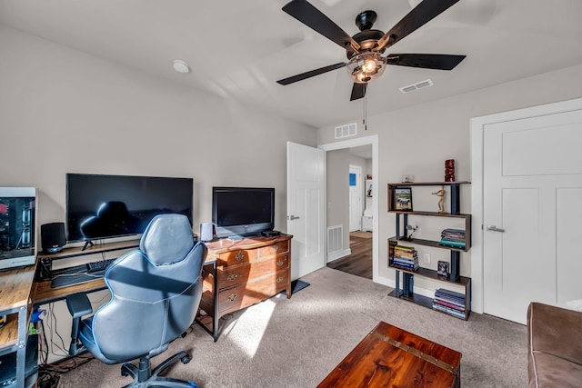 carpeted office with ceiling fan