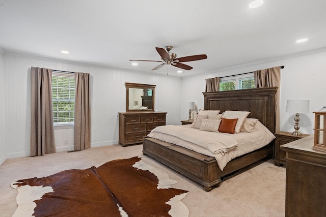 carpeted bedroom with ceiling fan and ornamental molding