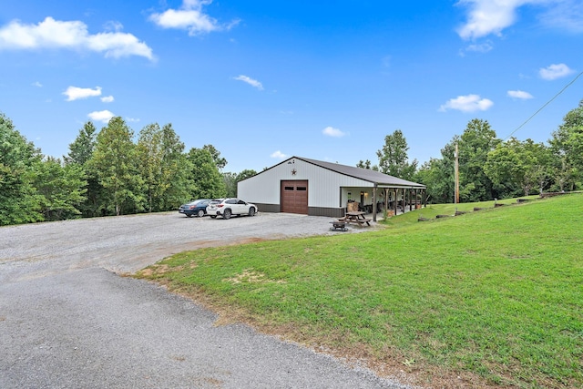 view of front of house featuring a front yard, an outbuilding, and a garage