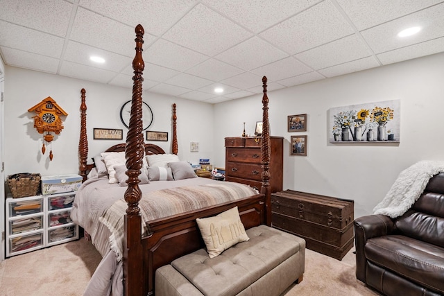 carpeted bedroom with a drop ceiling