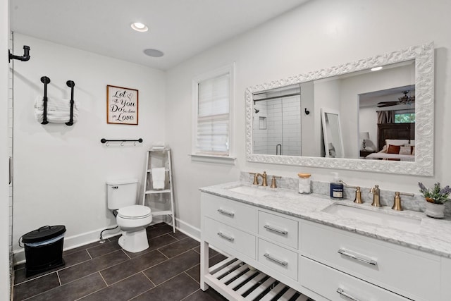 bathroom featuring tile patterned floors, vanity, toilet, walk in shower, and ceiling fan