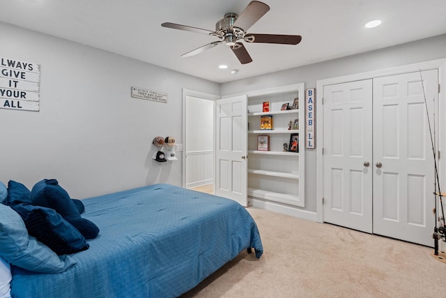 bedroom featuring ceiling fan, a closet, and carpet flooring