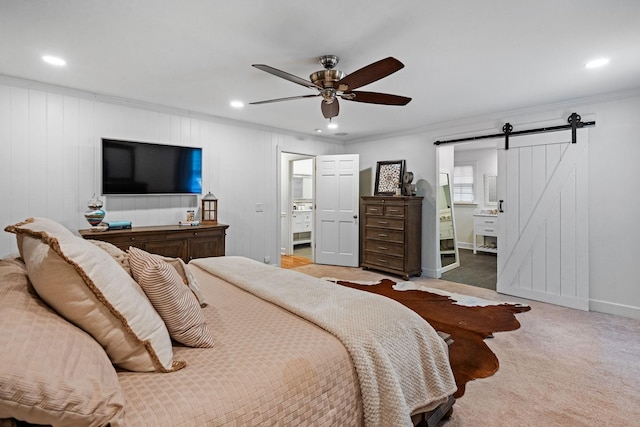 bedroom featuring ceiling fan, carpet, ornamental molding, and a barn door