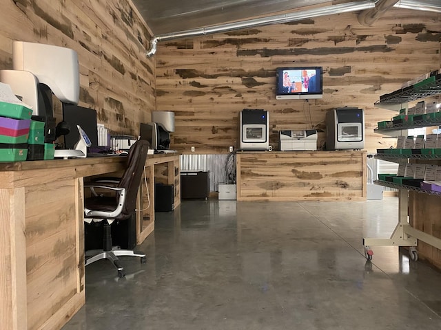 office featuring wood walls and a towering ceiling