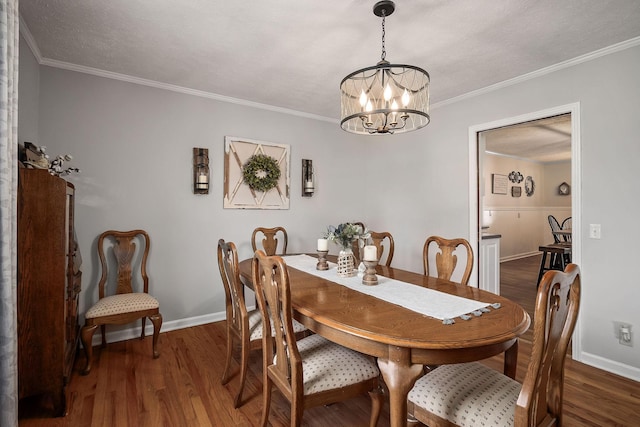 dining room with dark hardwood / wood-style floors, crown molding, and a notable chandelier