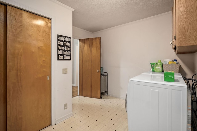 laundry area featuring crown molding, a textured ceiling, and cabinets