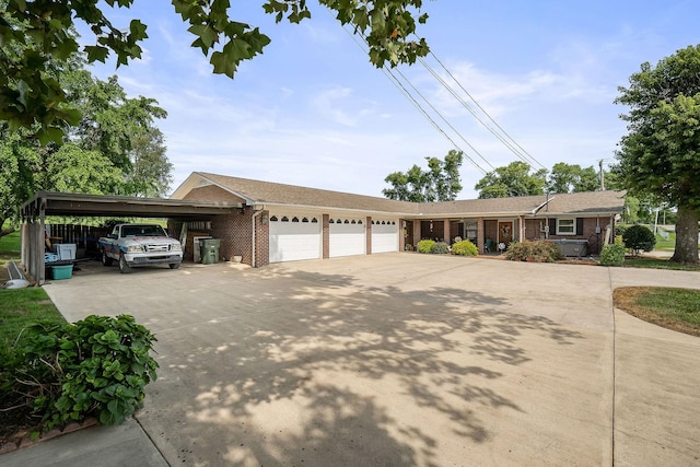 ranch-style house featuring a carport and a garage