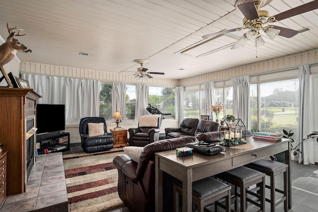 living room with ceiling fan and light tile patterned floors