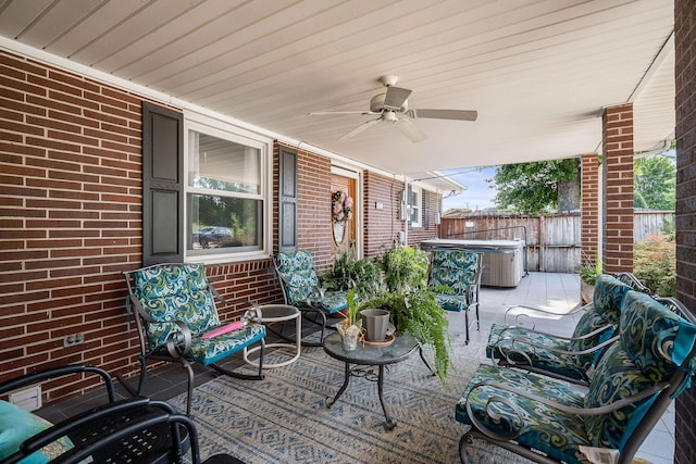 view of patio / terrace with ceiling fan and a hot tub