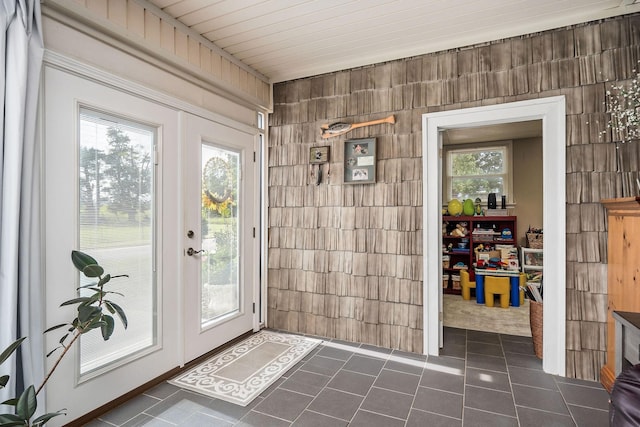 entryway featuring french doors and dark tile patterned floors