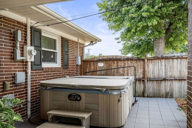 view of patio / terrace with a hot tub