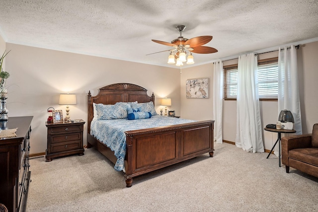 carpeted bedroom featuring a textured ceiling, ceiling fan, and ornamental molding