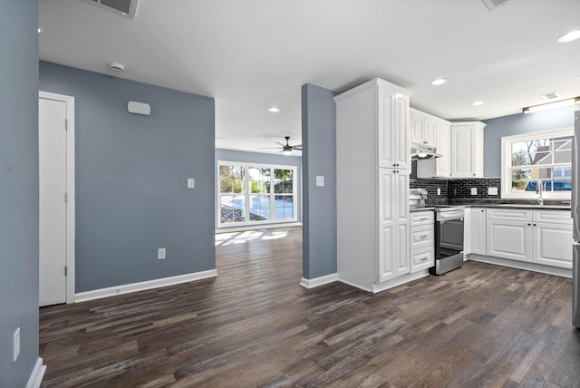 kitchen featuring dark hardwood / wood-style floors, stainless steel range with electric cooktop, and white cabinets