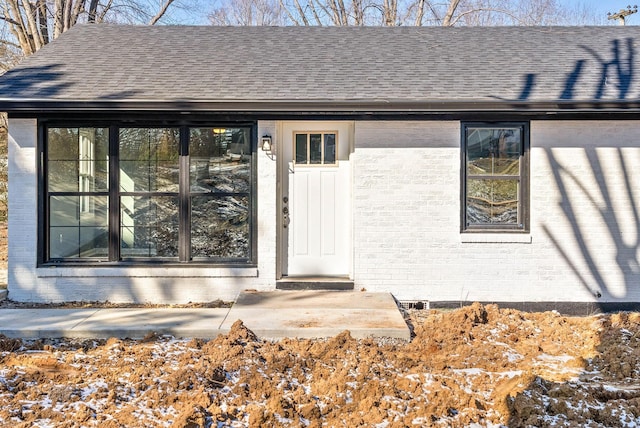 view of snow covered property entrance