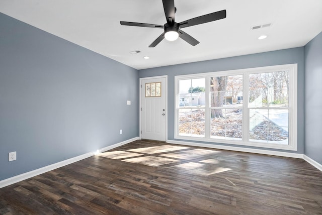 interior space with ceiling fan and dark hardwood / wood-style flooring