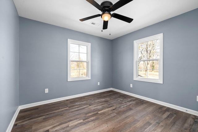 unfurnished room with ceiling fan and dark wood-type flooring