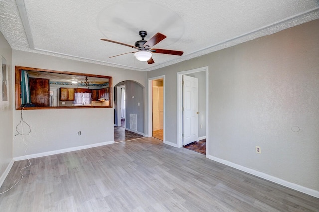 unfurnished living room with a textured ceiling, ceiling fan, and hardwood / wood-style flooring