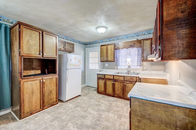 kitchen with white refrigerator and sink