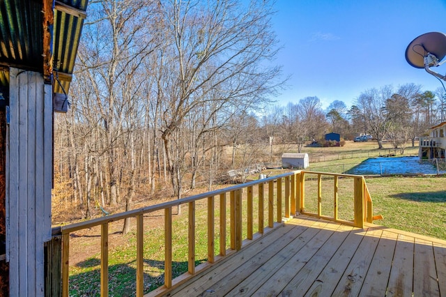 wooden deck featuring a lawn