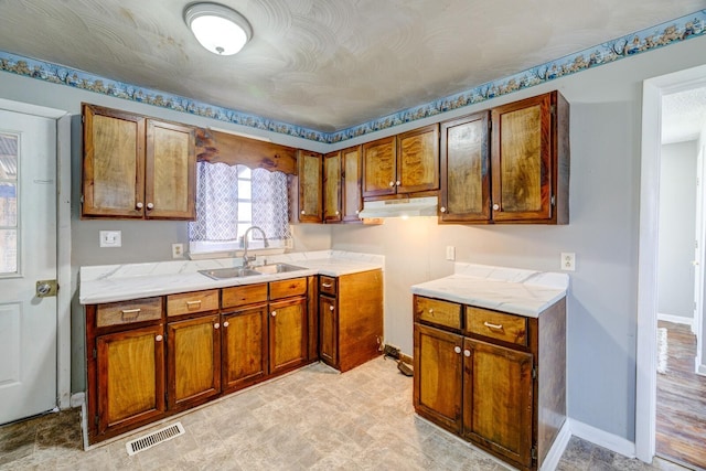 kitchen featuring sink and a textured ceiling