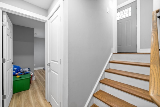 stairs featuring hardwood / wood-style floors