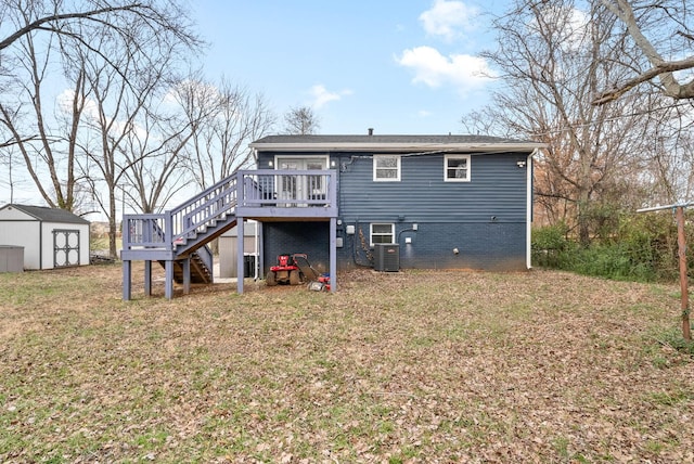 back of house featuring a storage shed, cooling unit, a deck, and a yard