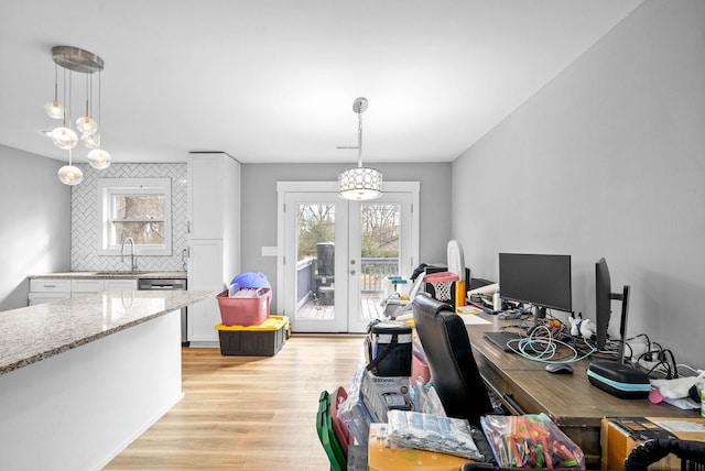 office with sink, french doors, and light wood-type flooring