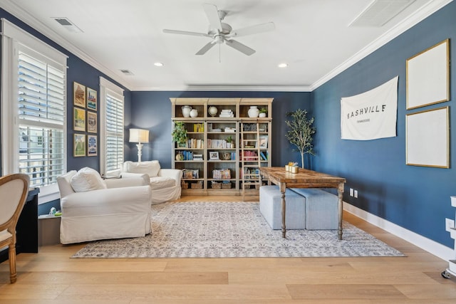 living area featuring ceiling fan, ornamental molding, and light hardwood / wood-style flooring