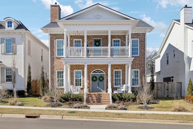 view of front of house with a porch and a balcony