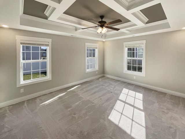 carpeted empty room with ceiling fan, ornamental molding, and coffered ceiling