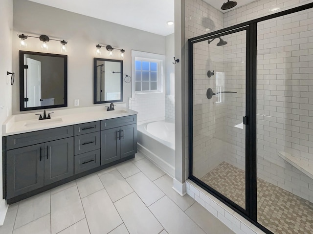 bathroom with tile patterned floors, vanity, and shower with separate bathtub