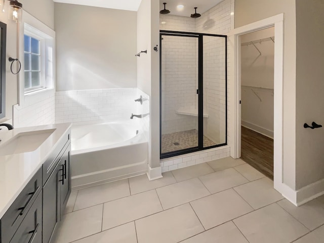 bathroom featuring tile patterned floors, vanity, and plus walk in shower