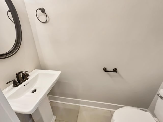 bathroom featuring sink, toilet, and tile patterned floors