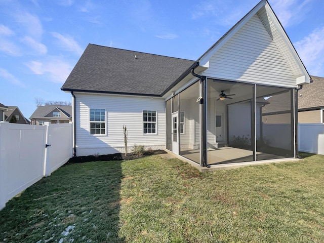 rear view of house with a yard, ceiling fan, and a patio