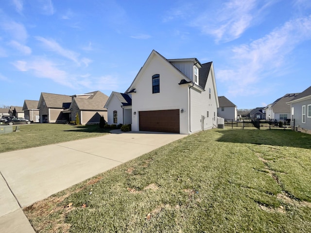 view of home's exterior with a garage and a lawn