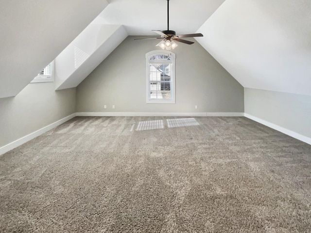 additional living space with ceiling fan, carpet floors, and lofted ceiling