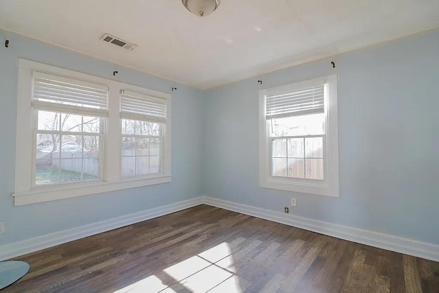 spare room with hardwood / wood-style flooring