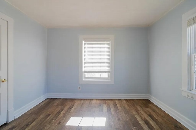 unfurnished room with dark hardwood / wood-style flooring