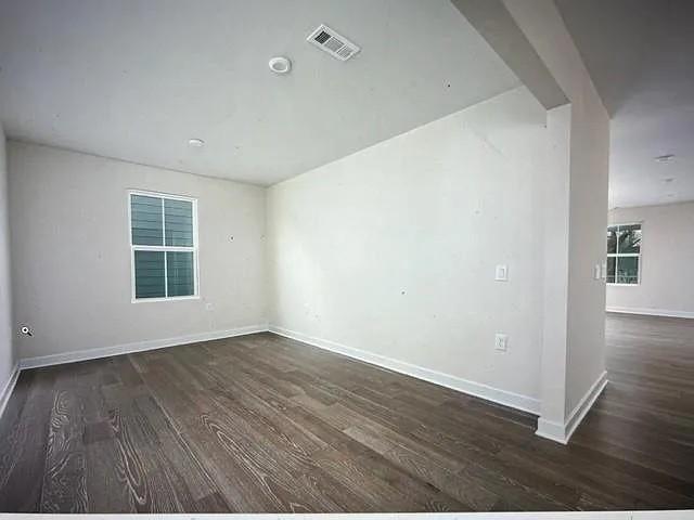 empty room featuring dark hardwood / wood-style flooring