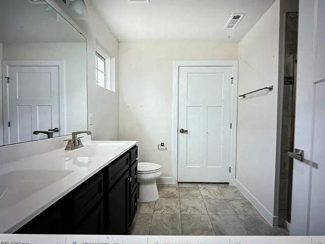 bathroom with toilet and vanity