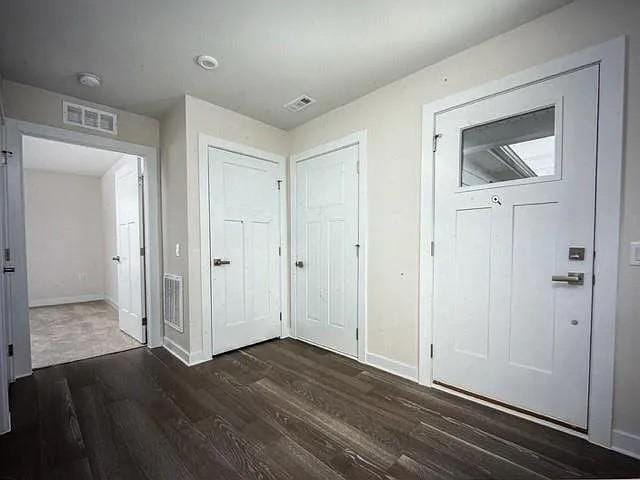 interior space with dark hardwood / wood-style floors